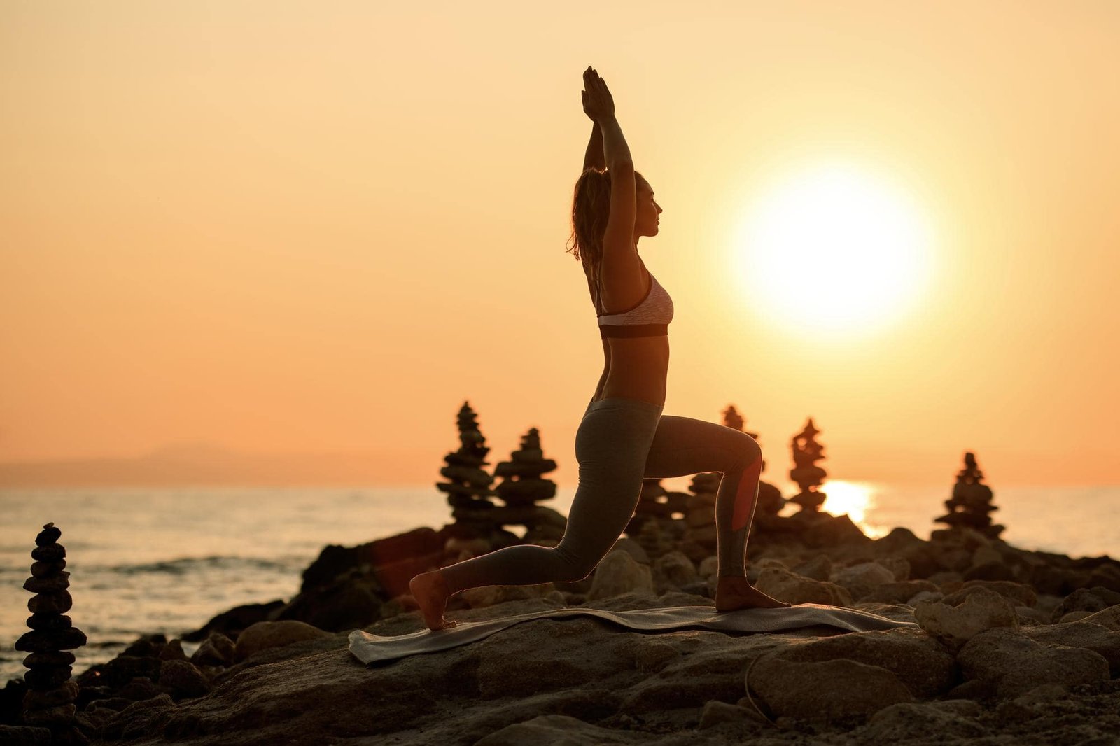 woman doing yoga pose on a mountain